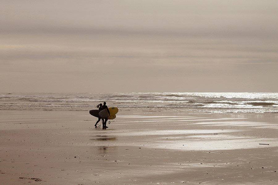 surfers on a beach in Portugal